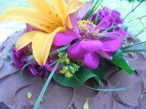chocolate cake with pink zinnias