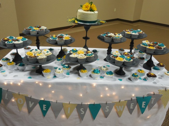 teal and yellow wedding cake and cupcakes dessert table